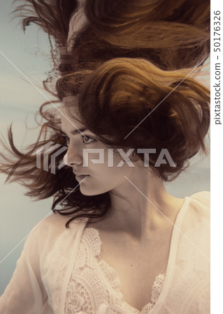 Portrait of a girl in a white dress under water 50176326