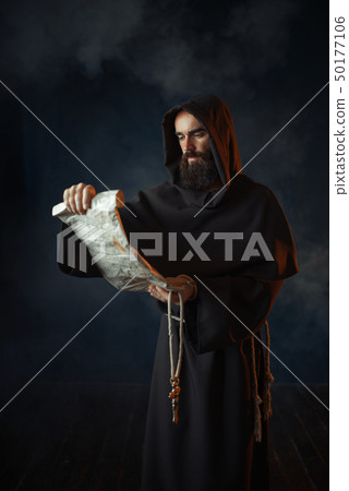 Medieval monk reads a prayer in ancient manuscript Medieval monk reads a prayer in ancient manuscript 50177106
