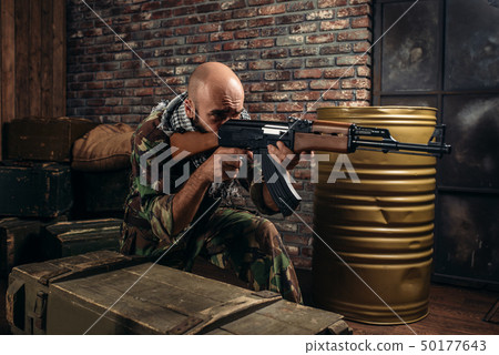 Terrorist in uniform shoots from kalashnikov rifle 50177643