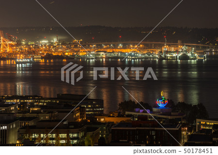 Orange lights iluminate the port of Seattle and Elliott Bay at night. Orange lights iluminate the port of Seattle and Elliott Bay at night. 50178451