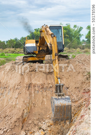 Yellow excavator machine working earth moving Yellow excavator machine working earth moving 50178596