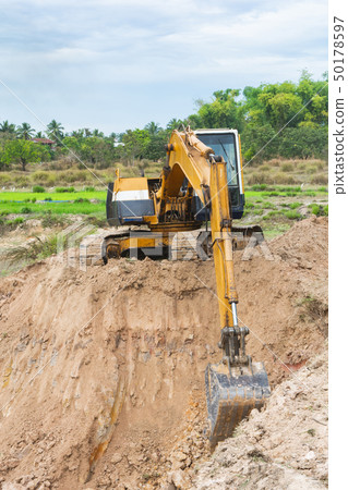 Yellow excavator machine working earth moving 50178597