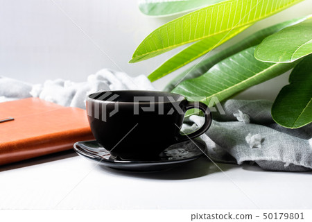 Coffee mug black with notebook and green leaves Coffee mug black with notebook and green leaves 50179801