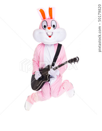 Man in a easter bunny costume plays music on guitar, jumps, have fun on white background. Funny hare Man in a easter bunny costume plays music on guitar, jumps, have fun on white background. Funny hare 50179820