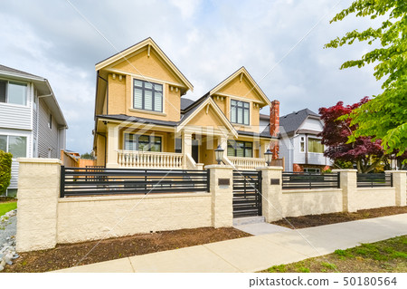 Newly renovated luxury residential house with concrete and metal fence for sale 50180564