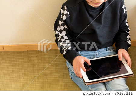 Studying modern age of elementary school boy learning playing with tablet 50183211