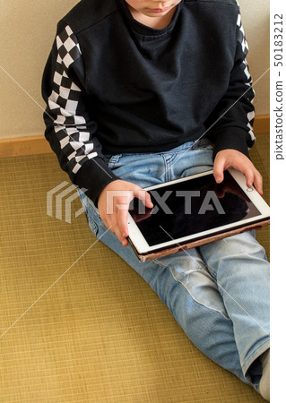 Studying modern age of elementary school boy learning playing with tablet 50183212