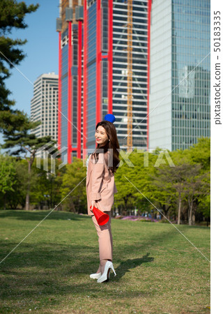 A business woman enjoying leisure time in Seoul's Yeouido Park on a sunny spring afternoon A business woman enjoying leisure time in Seoul's Yeouido Park on a sunny spring afternoon 50183335