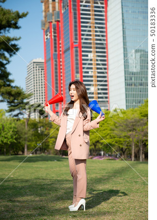 A business woman enjoying leisure time in Seoul's Yeouido Park on a sunny spring afternoon A business woman enjoying leisure time in Seoul's Yeouido Park on a sunny spring afternoon 50183336