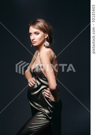 Sensual pregnant woman in sexy silk dress 50185605