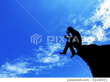 Silhouette of a depressed man on a cliff Silhouette of a depressed man on a cliff 50186931