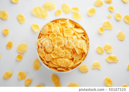 White cup with golden corn flakes, isolated on 50187320