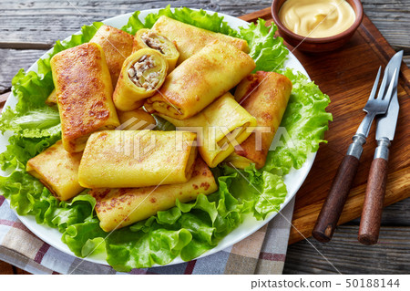 Savory crepe rolls with ground chicken meat 50188144