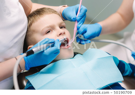 Young boy sitting on the dental chair at the office. Children's dentist examination baby teeth 50190709
