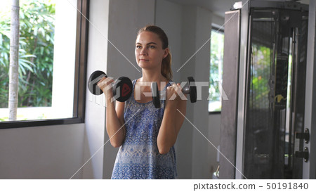 Fitness woman training dumbbell exercise in gym Fitness woman training dumbbell exercise in gym 50191840