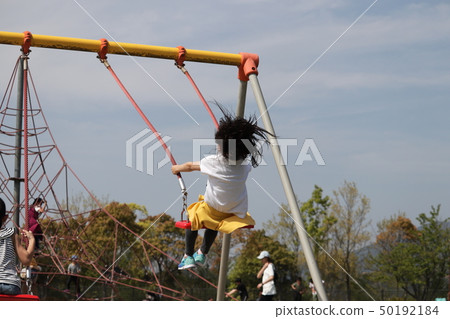 Girl on a swing 50192184
