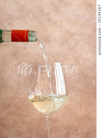White wine pouring into glass White wine pouring into glass 50194167