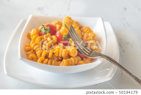 Portion of pasta with tomato and ricotta pesto 50194179