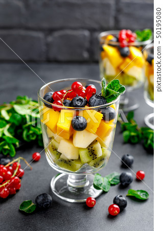 Fresh salad with fruits and berries in glass. Fresh salad with fruits and berries in glass. 50195080