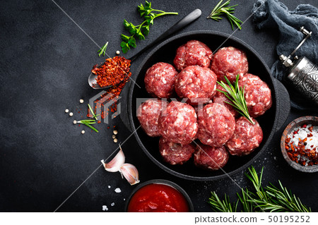 Fresh raw beef meatballs with spices and tomato Fresh raw beef meatballs with spices and tomato 50195252