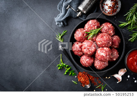 Fresh raw beef meatballs with spices and tomato Fresh raw beef meatballs with spices and tomato 50195253