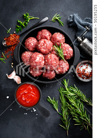 Fresh raw beef meatballs with spices and tomato Fresh raw beef meatballs with spices and tomato 50195255