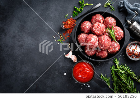 Fresh raw beef meatballs with spices and tomato Fresh raw beef meatballs with spices and tomato 50195256