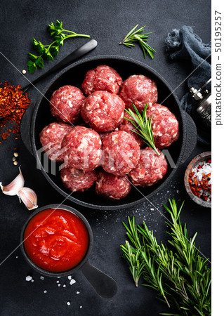 Fresh raw beef meatballs with spices and tomato Fresh raw beef meatballs with spices and tomato 50195257