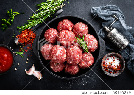 Fresh raw beef meatballs with spices and tomato Fresh raw beef meatballs with spices and tomato 50195259