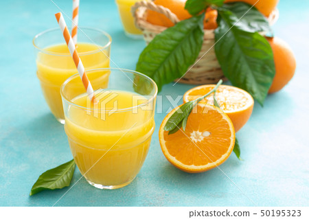 Orange freshly squeezed juice in glass and fresh Orange freshly squeezed juice in glass and fresh 50195323