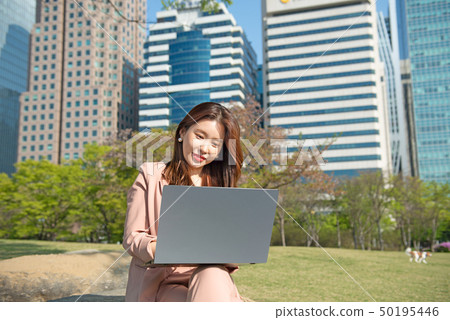 Business woman working with notebook at Yeouido building in Korea Business woman working with notebook at Yeouido building in Korea 50195446