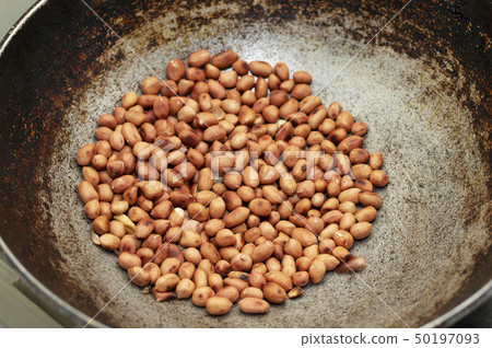 Roasting peanut in a frying pan, Maharashtra India Roasting peanut in a frying pan, Maharashtra India 50197093
