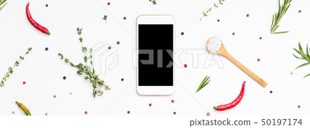 Smartphone with greens herbs and spices around Smartphone with greens herbs and spices around 50197174