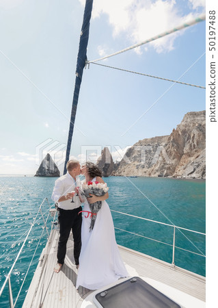 A Just married couple on yacht. Happy bride and groom on their wedding day 50197488