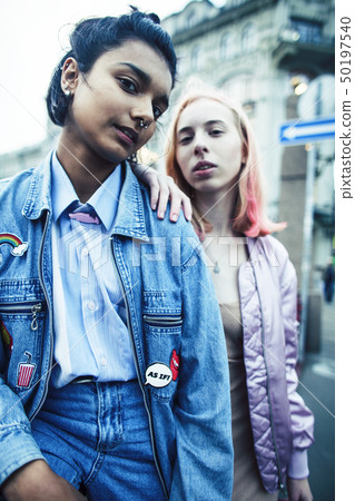 Two teenage girls infront of university building smiling, having fun, lifestyle real people concept 50197540