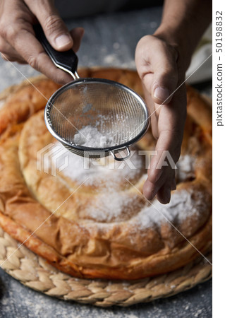 man preparing ensaimada typical of Mallorca, Spain man preparing ensaimada typical of Mallorca, Spain 50198832