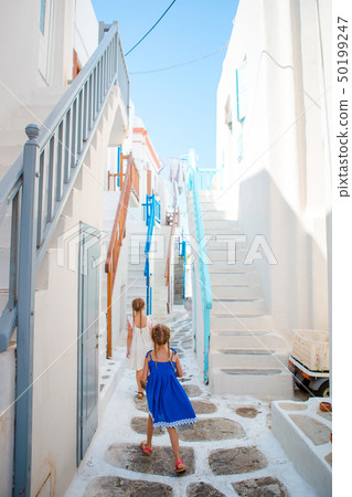 Adorable little girl at old street of typical greek traditional village Adorable little girl at old street of typical greek traditional village 50199247