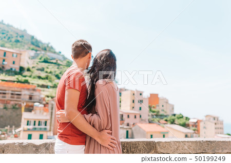 Tourists looking at scenic view of Riomaggiore, Cinque Terre, Liguria, Italy Tourists looking at scenic view of Riomaggiore, Cinque Terre, Liguria, Italy 50199249