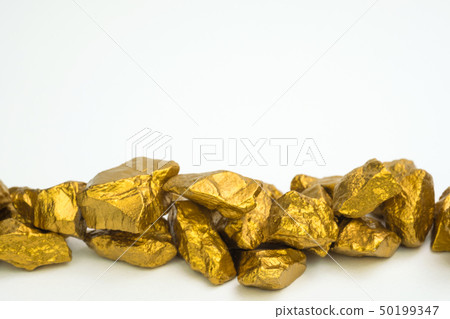 A pile of gold nuggets or gold ore isolated on A pile of gold nuggets or gold ore isolated on 50199347