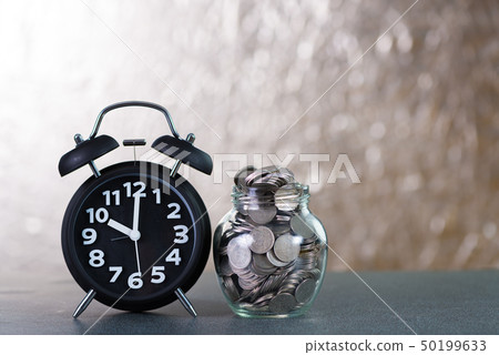 Alarm clock and step of coins stacks with coin in 50199633