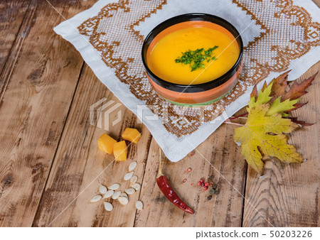 pumpkin soup bowl on rustic wooden background 50203226