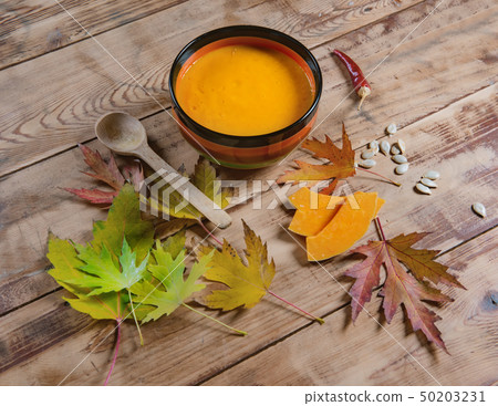 pumpkin soup bowl on rustic wooden background pumpkin soup bowl on rustic wooden background 50203231