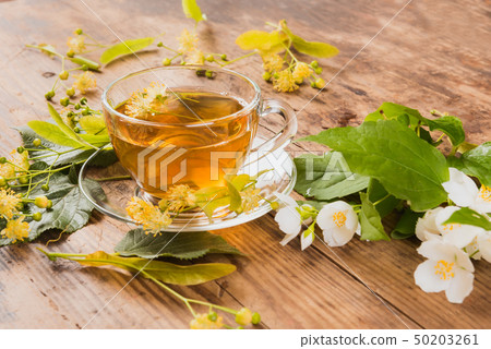 Cup of tea linden jasmine on wooden background Cup of tea linden jasmine on wooden background 50203261
