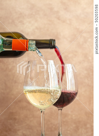 White and red wine pouring into glasses 50203598