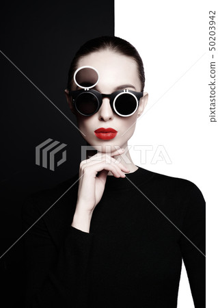 beautiful young woman with black sunglasses 50203942