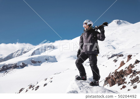 Growth Portrait bearded male skier aged against background of snow-capped Caucasus mountains. An Growth Portrait bearded male skier aged against background of snow-capped Caucasus mountains. An 50204492