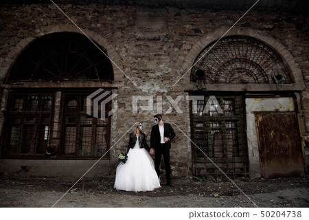 Dressed in wedding clothes romantic zombie couple. 50204738