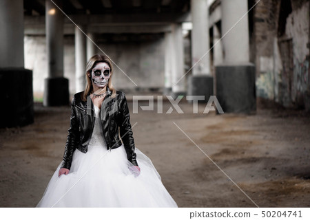 Portrait of zombie woman with painted skull face 50204741