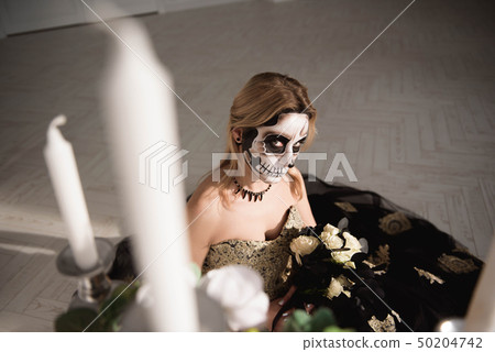 Portrait of zombie woman with painted skull face 50204742