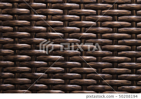 Close-up Dark brown background is an element of wicker furniture made of polymer fibers. Synthetic 50208194
